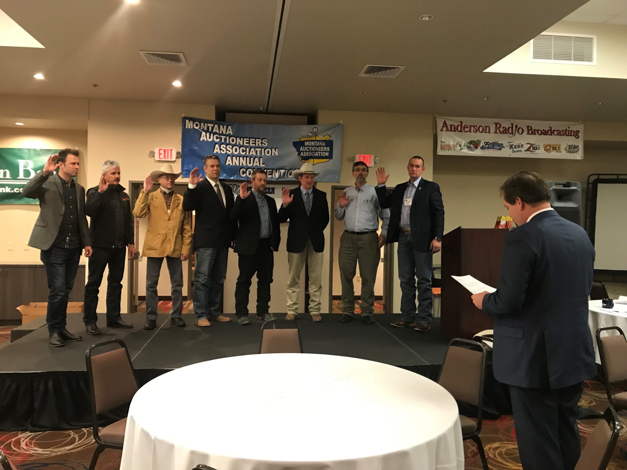 Tim Mast swears in the 2019 Montana Auctioneer Board of Directors. Left to right: Wade Affleck, Merton Musser, Robert McDowell III, JK Kinsey, Brian Young, Kevin Hill, Gideon Yutzy and Reed Tobol